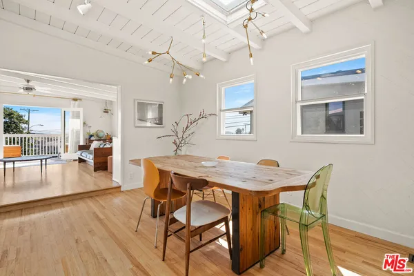 a dining room with furniture and wooden floor