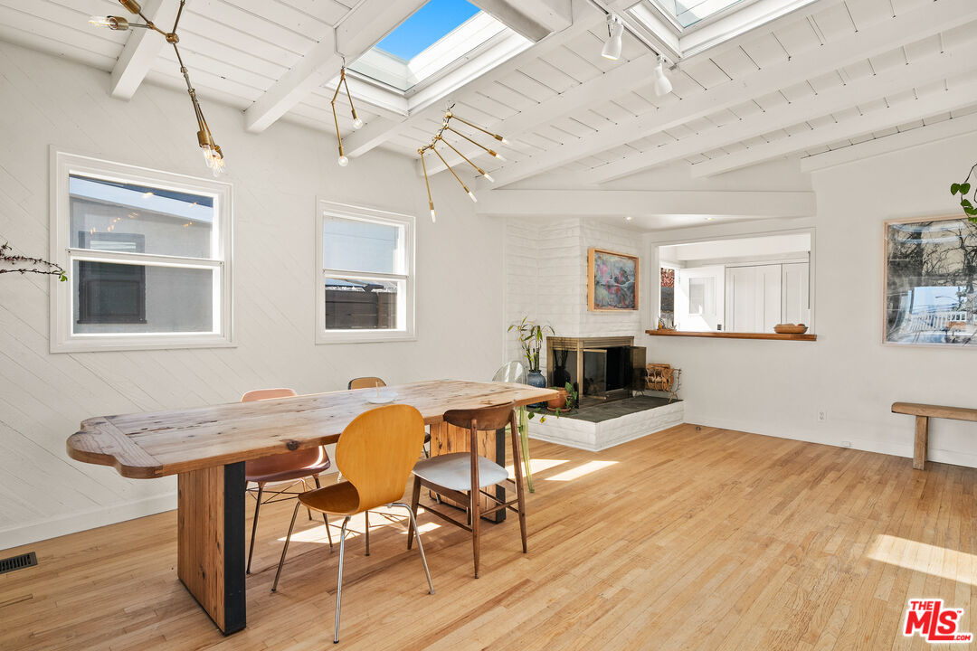 7421 Earldom Avenue Playa del Rey, CA 90293 - Photo 16 of 34 a view of a livingroom with furniture a dining table and wooden floor