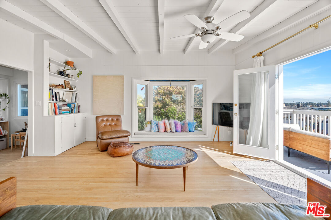 7421 Earldom Avenue Playa del Rey, CA 90293 - Photo 19 of 34 a living room with furniture a rug and a large window
