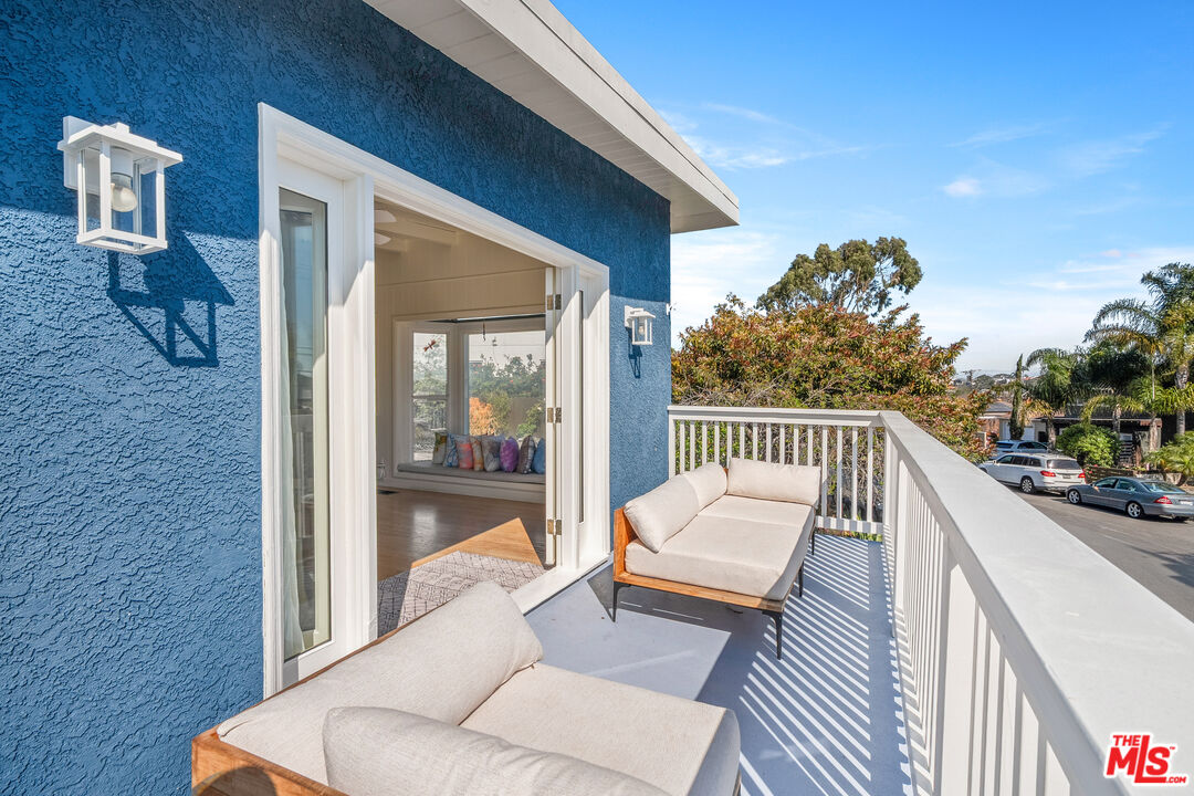 7421 Earldom Avenue Playa del Rey, CA 90293 - Photo 21 of 34 a balcony with furniture and a potted plant
