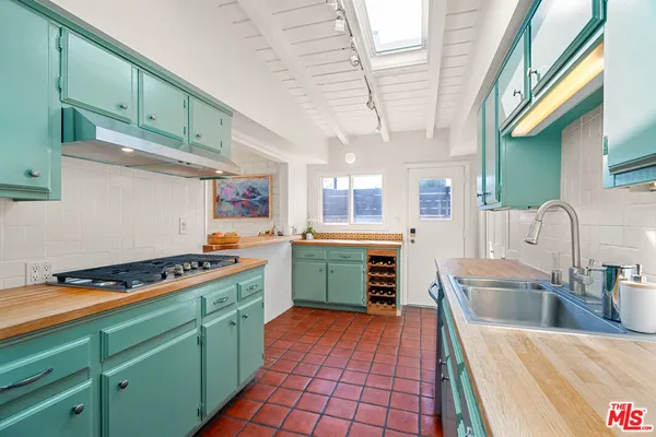 a kitchen with stainless steel appliances granite countertop a sink and cabinets