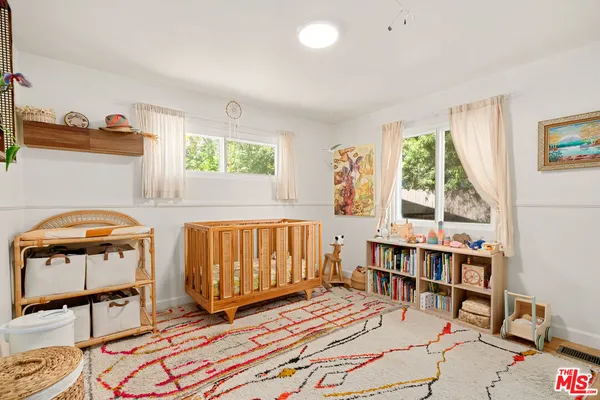 a bedroom with furniture and a window