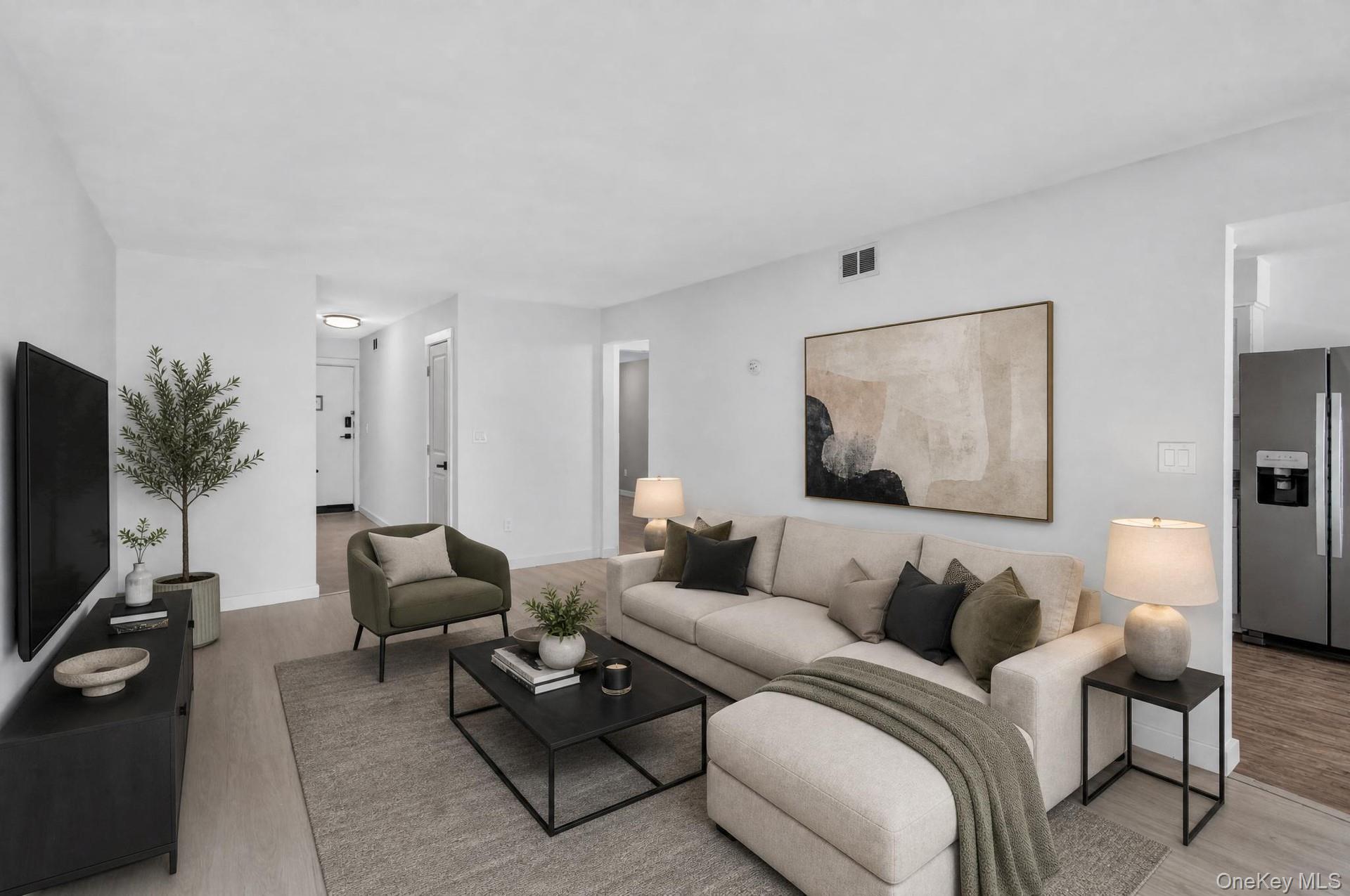 26 Cooper Road, Unit 414 Poughkeepsie, NY 12603 - Photo 5 of 24 Bright living area featuring light-toned wood-finish flooring and neutral wall tones