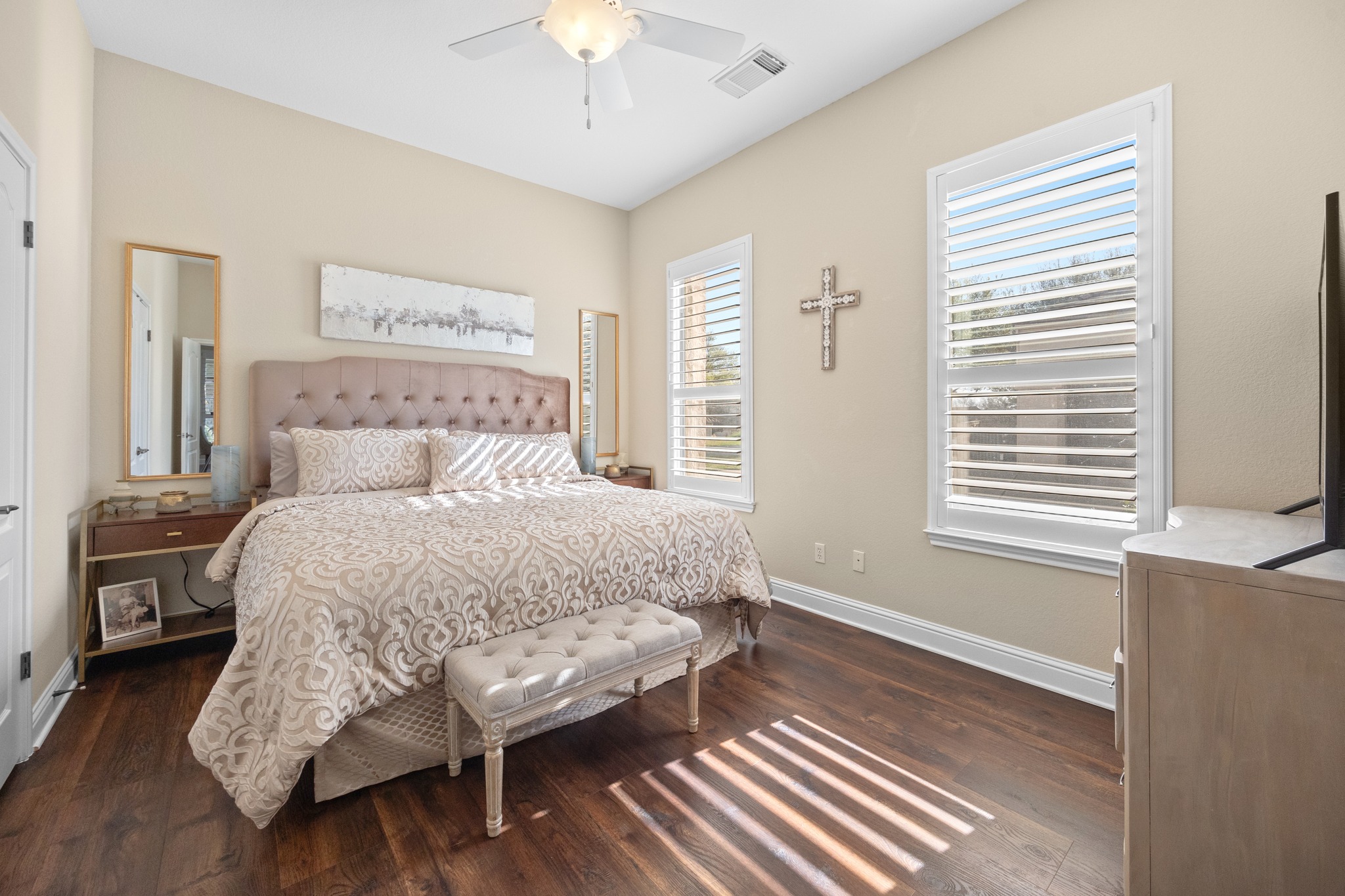 4 Hightrail Way The Hills, TX 78738 - Photo 12 of 35 a bed sitting in a bedroom next to a window and a chandelier