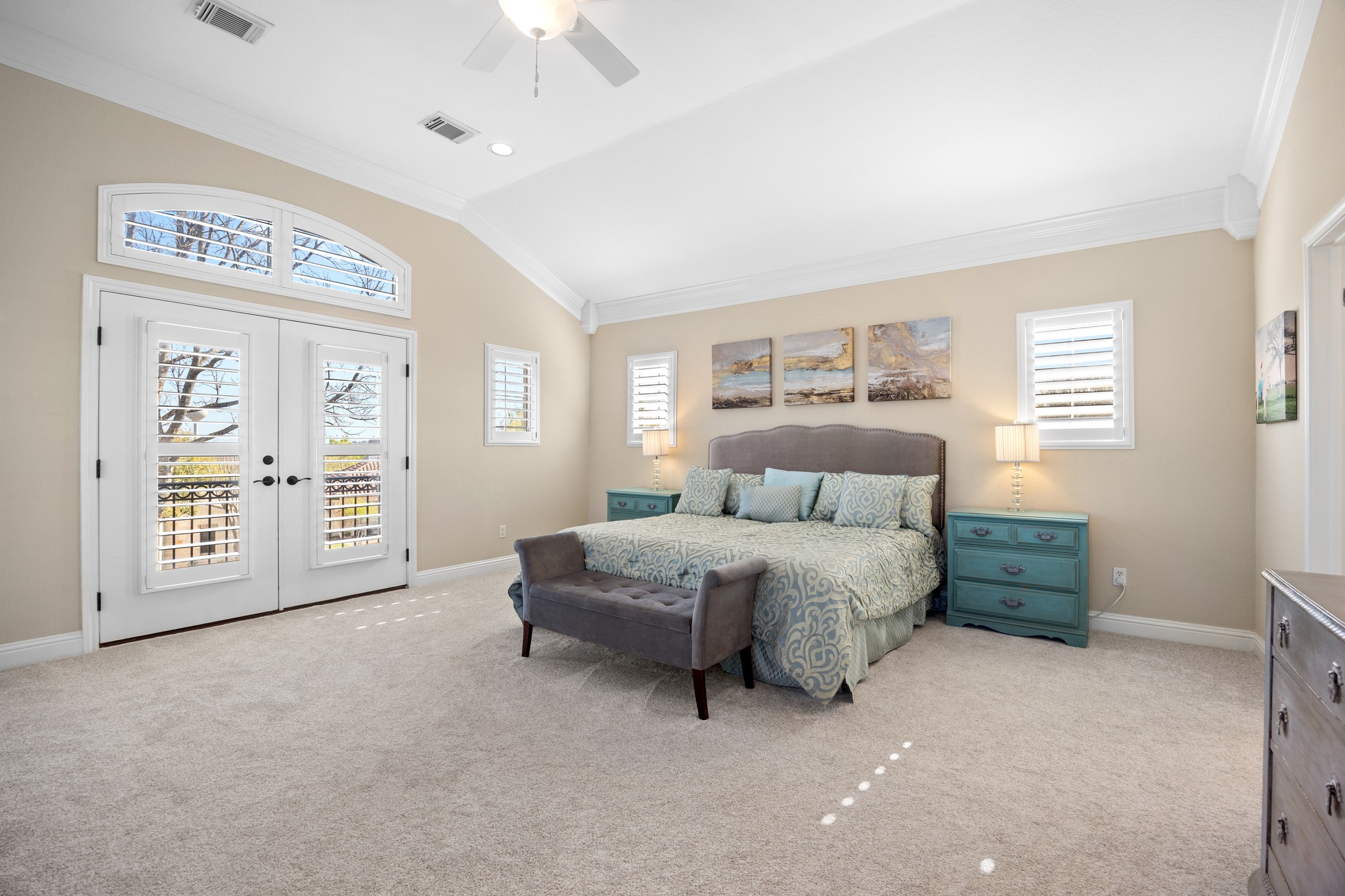 4 Hightrail Way The Hills, TX 78738 - Photo 19 of 35 a spacious bedroom with a bed a lamp and a large window