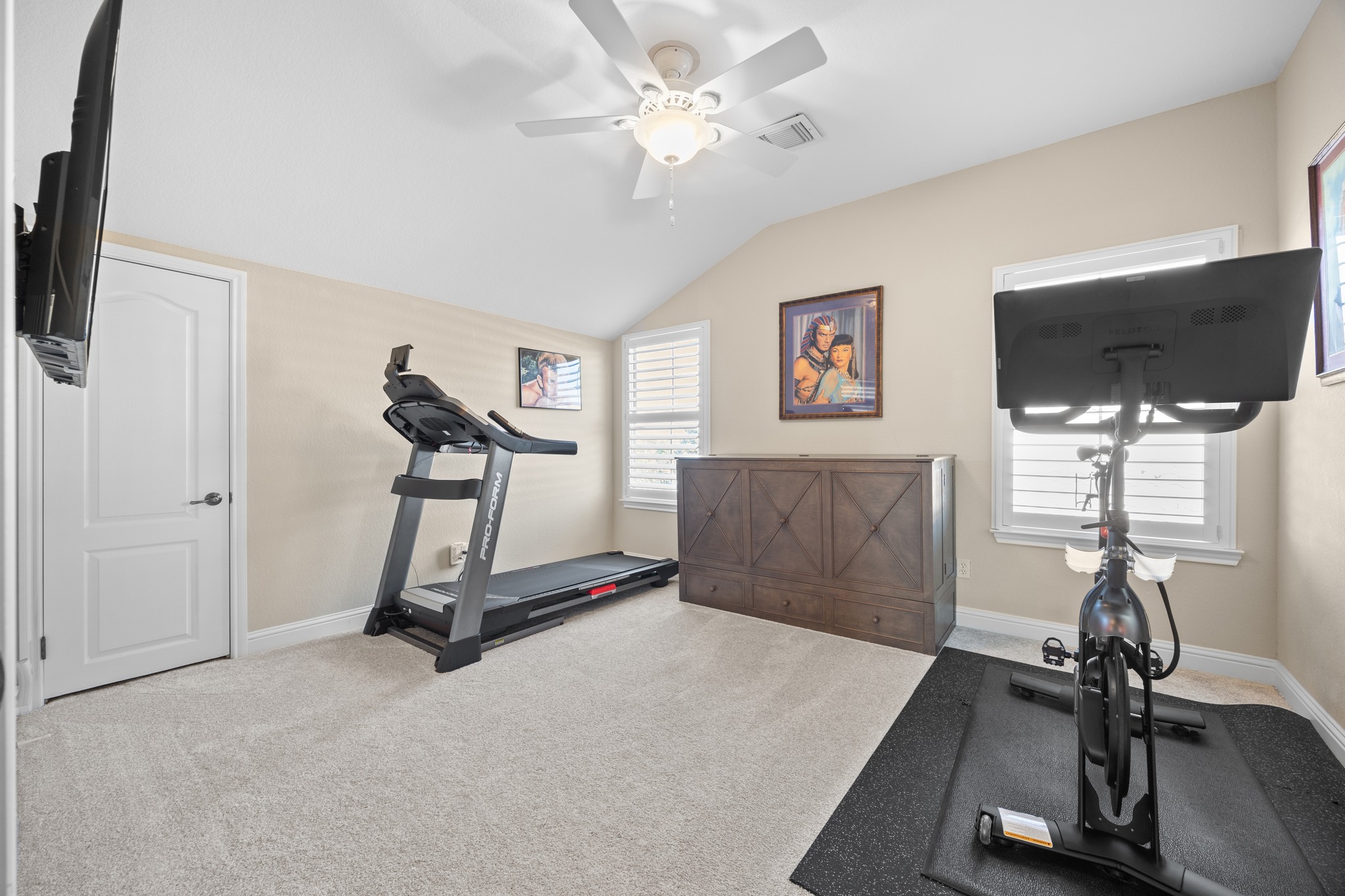 4 Hightrail Way The Hills, TX 78738 - Photo 23 of 35 a room with gym equipment and a flat screen tv