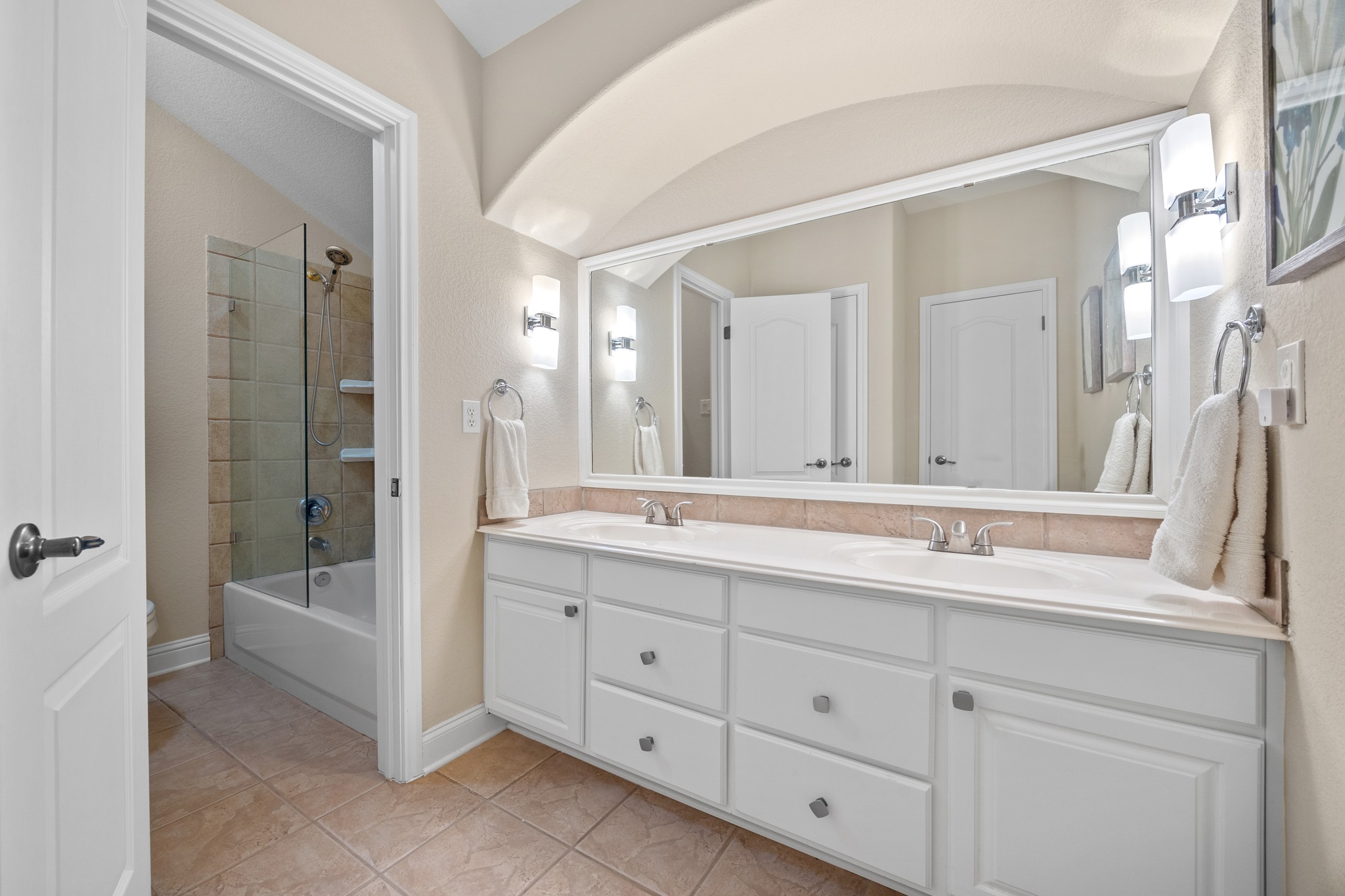 4 Hightrail Way The Hills, TX 78738 - Photo 24 of 35 a bathroom with double vanity sink a two mirror a window and a bathtub