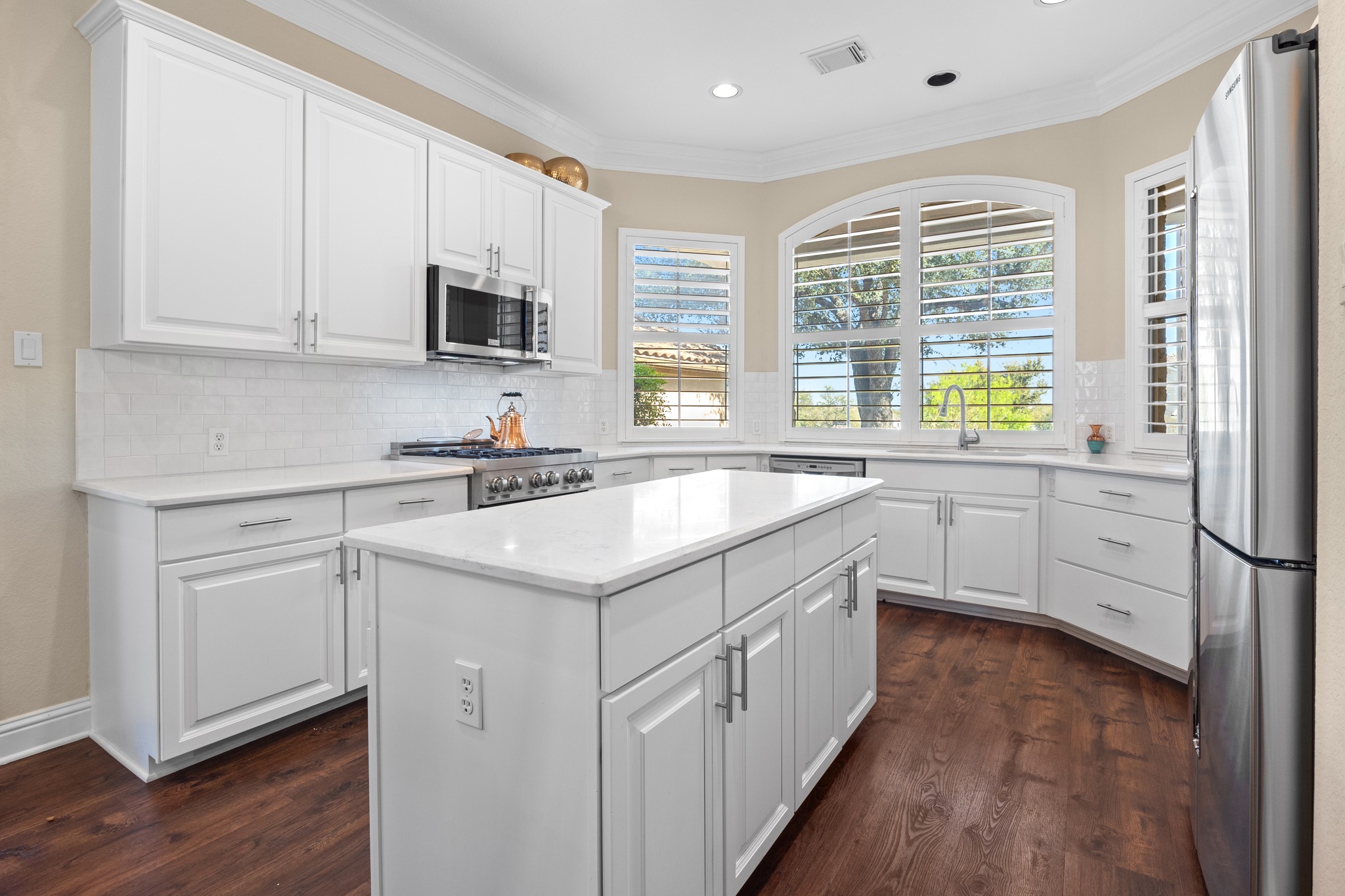 4 Hightrail Way The Hills, TX 78738 - Photo 6 of 35 a kitchen with granite countertop a sink and white cabinets