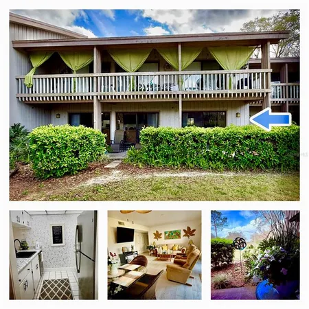 a view of a house with a small deck and a garden