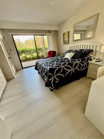 a large bed sitting in a bedroom next to a window