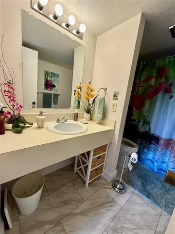 a bathroom with a sink mirror and vanity