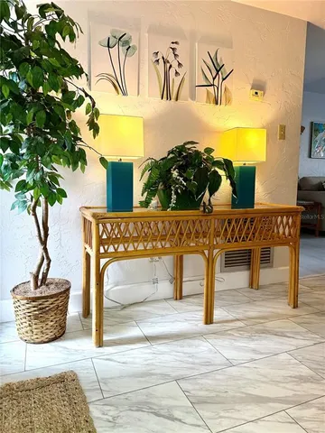 a living room with furniture and a potted plant