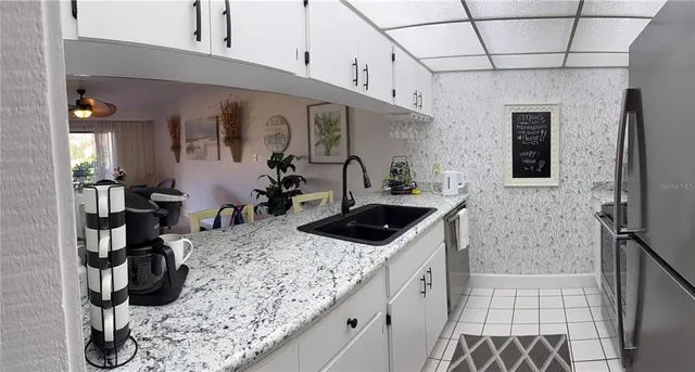 a kitchen with stainless steel appliances granite countertop a sink a stove and cabinets