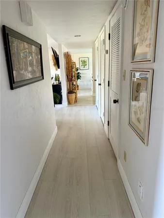 a view of a hallway with wooden floor