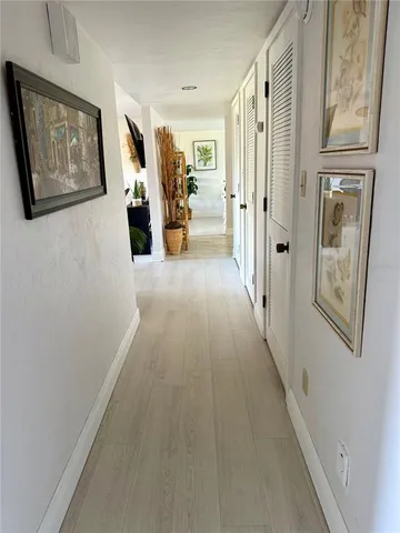 a view of a hallway with wooden floor