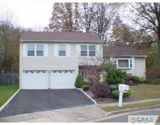 49 Meredith Road Edison, NJ 08817 - Photo 1 of 18 a front view of a house with a yard and garage
