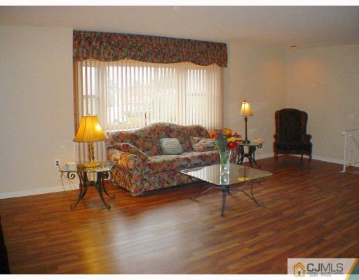 49 Meredith Road Edison, NJ 08817 - Photo 2 of 18 a living room with furniture and a wooden floor