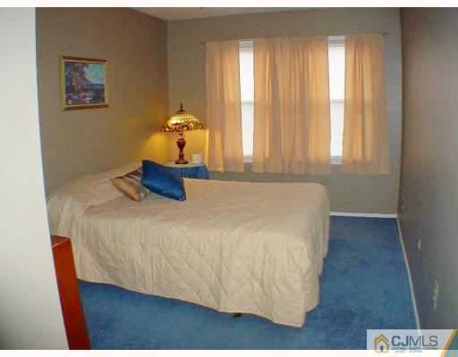 49 Meredith Road Edison, NJ 08817 - Photo 7 of 18 a bedroom with a bed and window