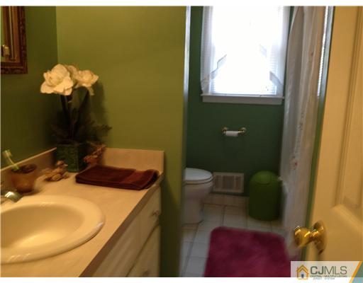 49 Meredith Road Edison, NJ 08817 - Photo 9 of 18 a bathroom with a sink toilet and mirror