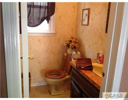 49 Meredith Road Edison, NJ 08817 - Photo 10 of 18 a bathroom with a toilet and a shower curtain