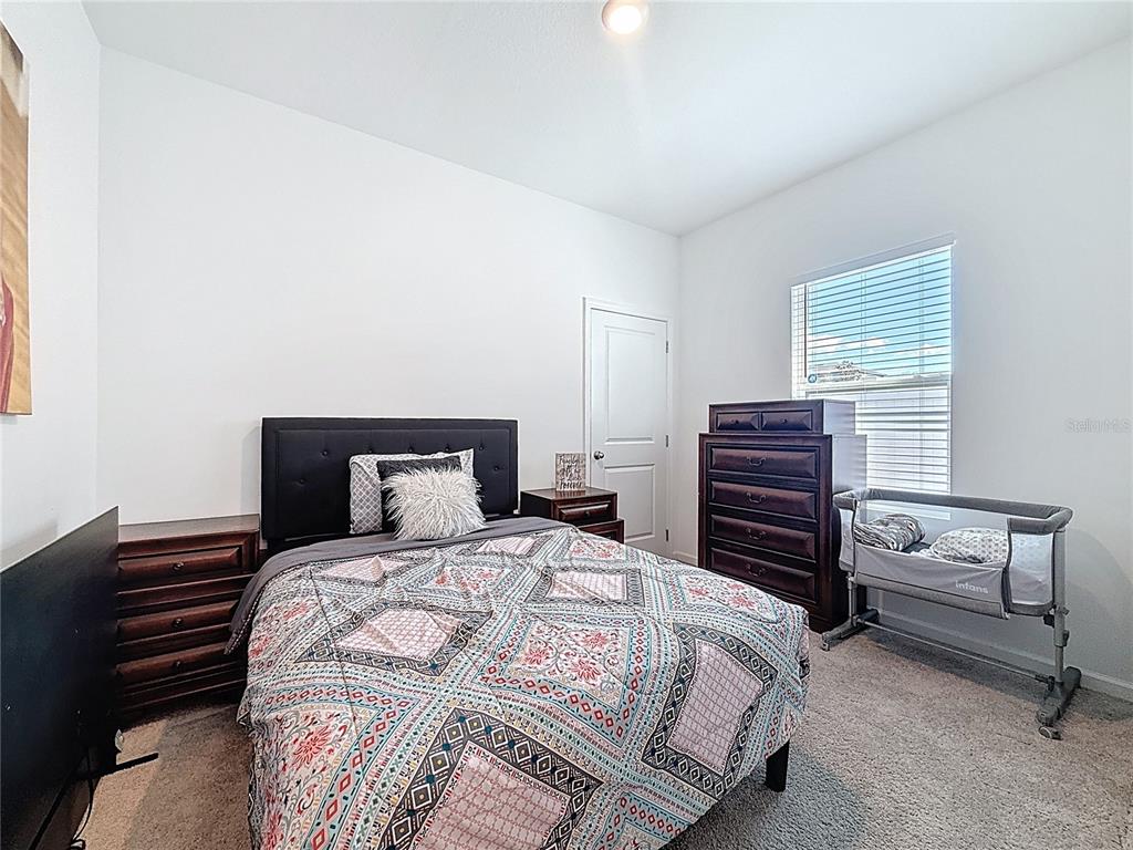 2030 Hemingway Circle Groveland, FL 34736 - Photo 11 of 21 a bedroom with a bed and dresser