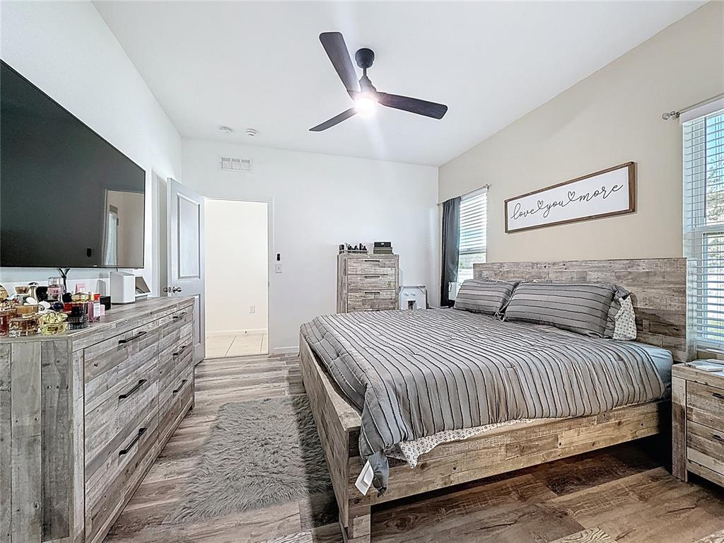 2030 Hemingway Circle Groveland, FL 34736 - Photo 13 of 21 a bedroom with a bed and a flat screen tv