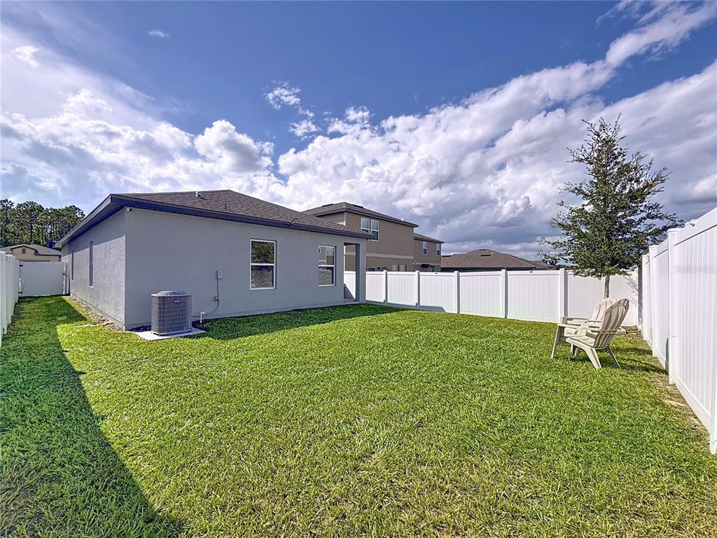 2030 Hemingway Circle Groveland, FL 34736 - Photo 16 of 21 a view of a backyard with a garden