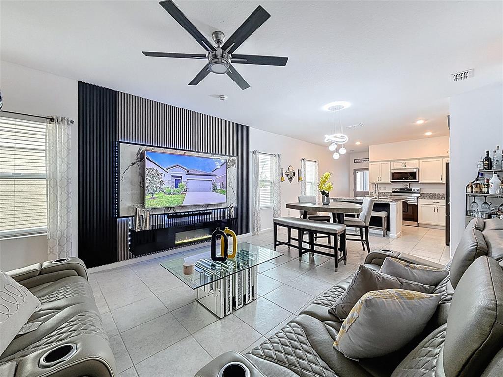 2030 Hemingway Circle Groveland, FL 34736 - Photo 4 of 21 a living room with furniture and a flat screen tv