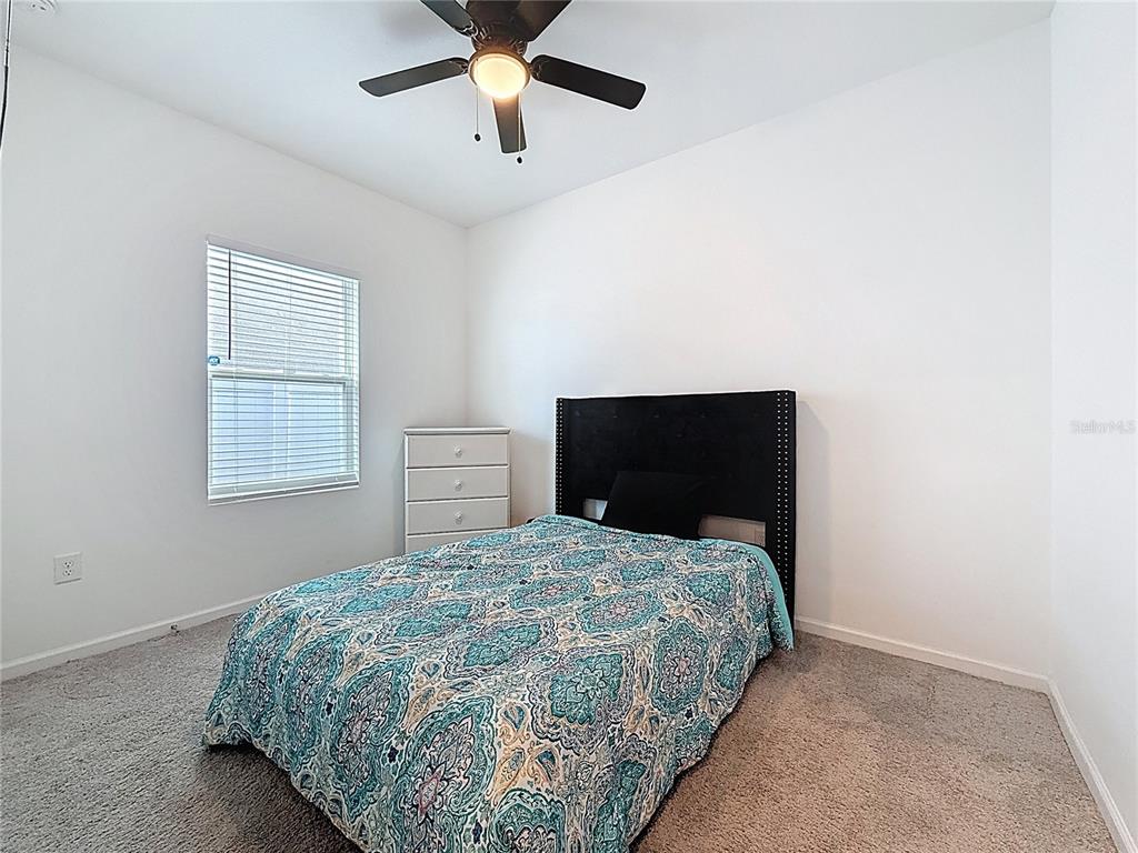 2030 Hemingway Circle Groveland, FL 34736 - Photo 9 of 21 a bedroom with a bed and a ceiling fan