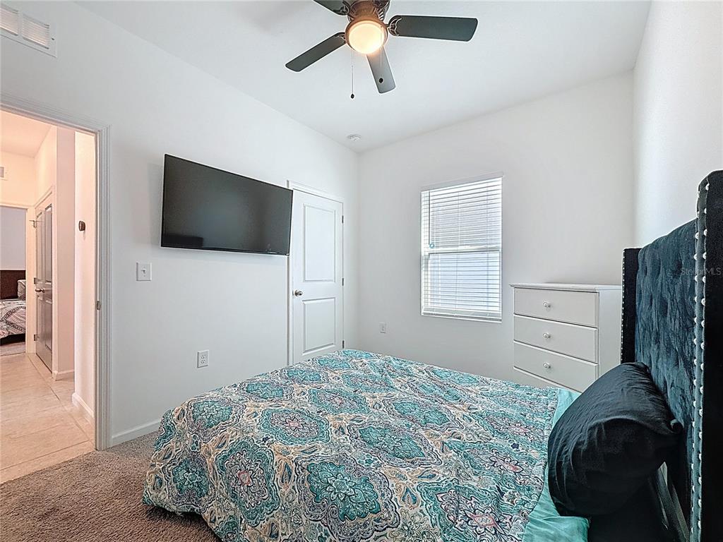 2030 Hemingway Circle Groveland, FL 34736 - Photo 10 of 21 a bedroom with a bed and a flat screen tv