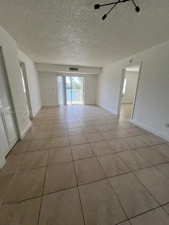 a kitchen with a refrigerator and a stove top oven