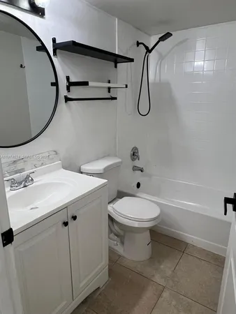 a bathroom with a toilet sink and shower