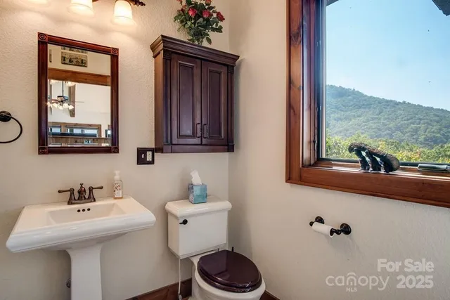 a bathroom with a toilet sink and mirror