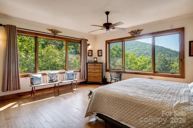 a bedroom with a bed and a large window