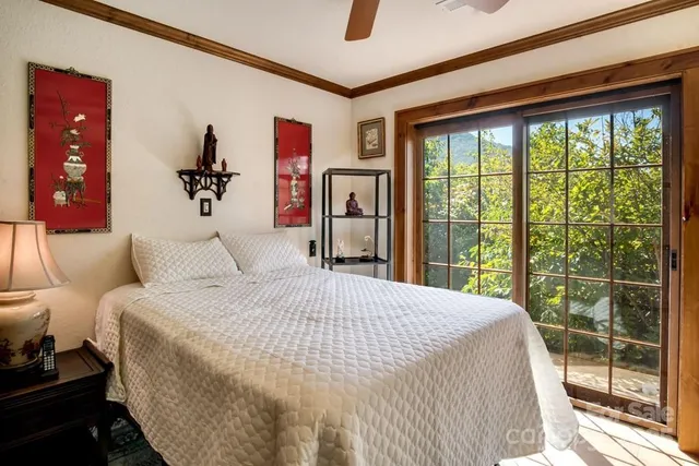 a bedroom with a large bed and a large window