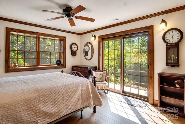 a bedroom with a bed and a large window