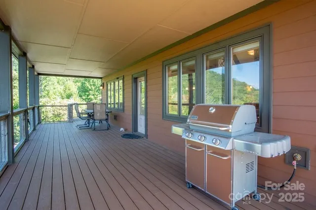 a living room with furniture and large windows