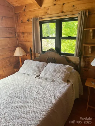a large bed sitting in a bedroom next to a window