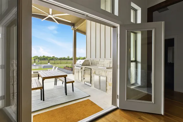 a view of a balcony with furniture and floor to ceiling windows