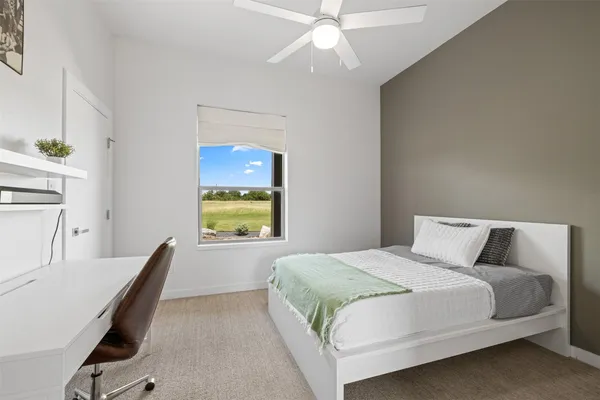 a bedroom with a large bed and a chandelier