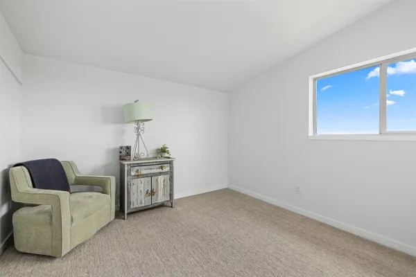 a living room with furniture and a lamp