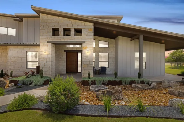 a front view of a house with garden