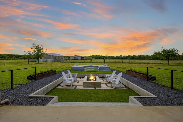 a view of a lake with a garden and outdoor seating
