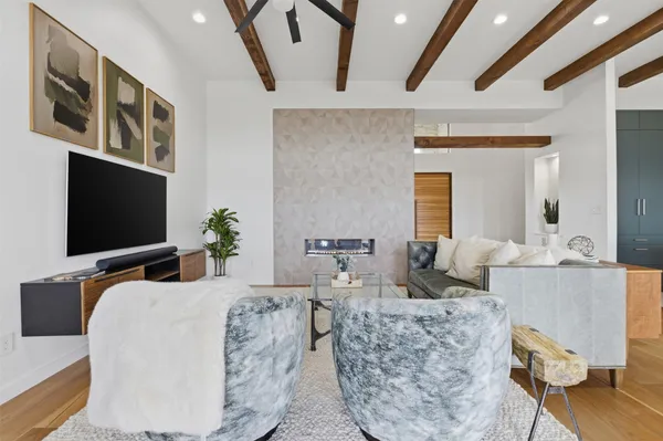 a bedroom with furniture and a flat screen tv