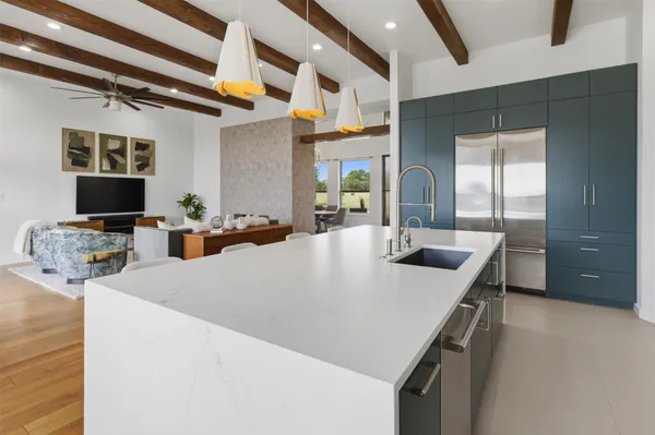 a kitchen with stainless steel appliances a sink and a refrigerator