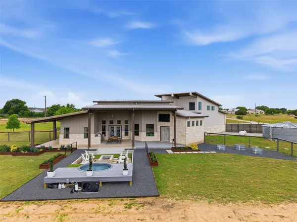 a front view of a house with swimming pool yard and outdoor seating