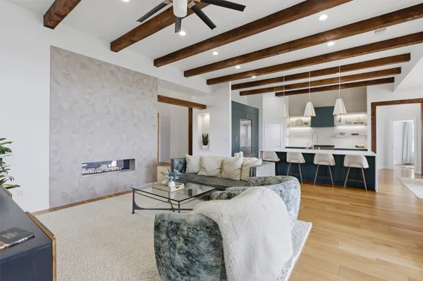 a living room with furniture and wooden floor