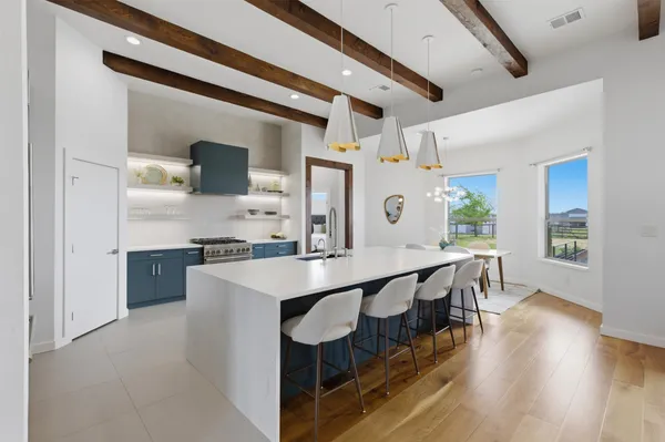 a kitchen with sink cabinets and wooden floor