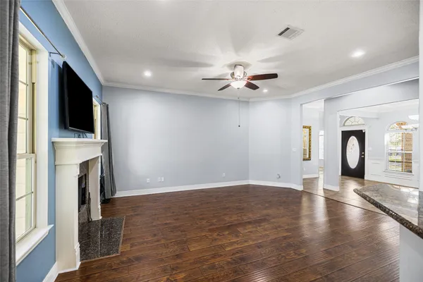a kitchen with granite countertop a refrigerator and a stove top oven