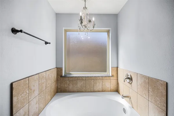 a bathroom with a granite countertop sink a mirror and a shower